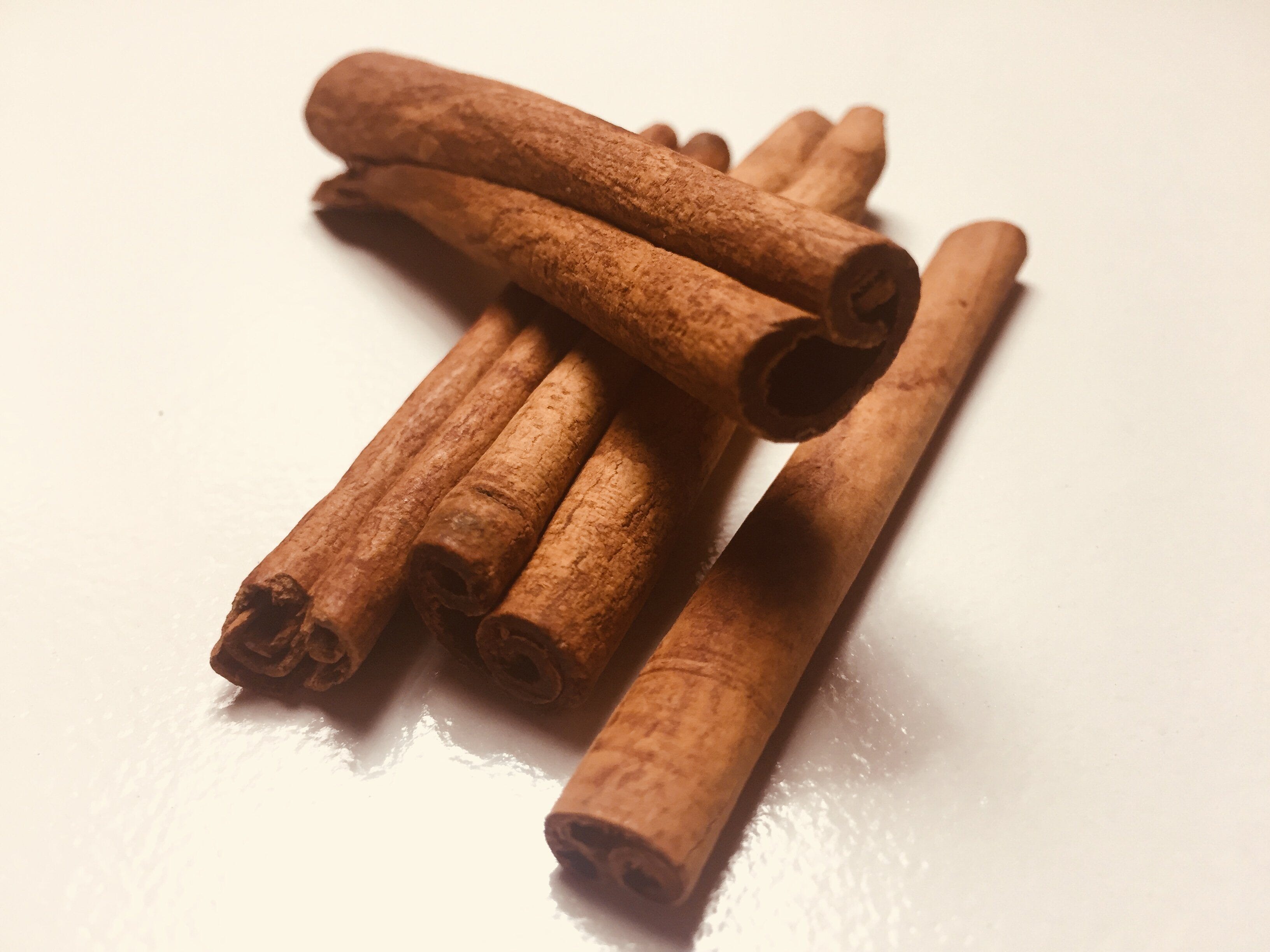 Pile of cinnamon sticks showing rolled layers and texture